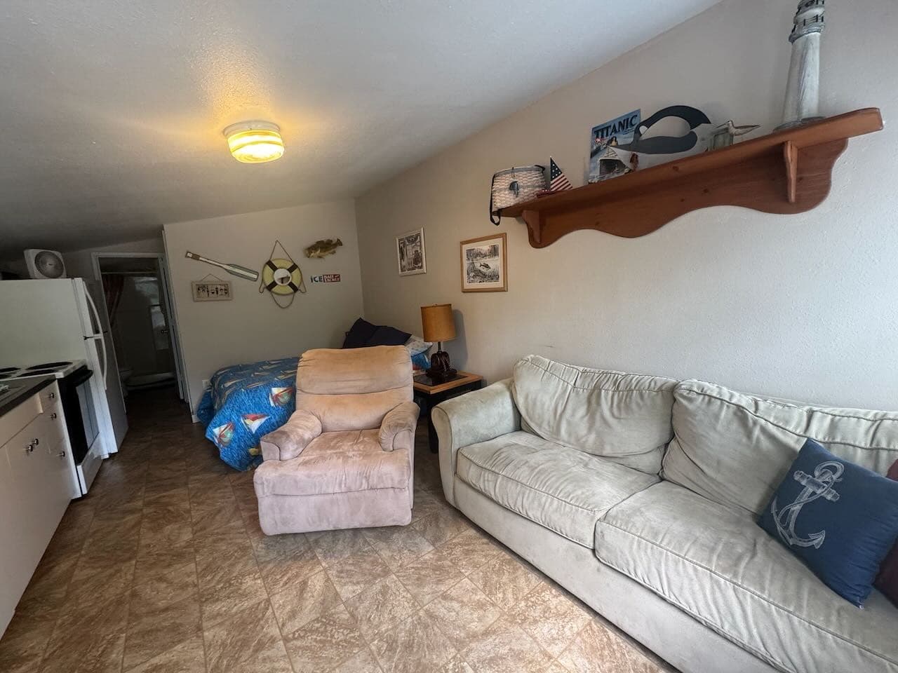 Living area with sofa and lighthouse shelf
